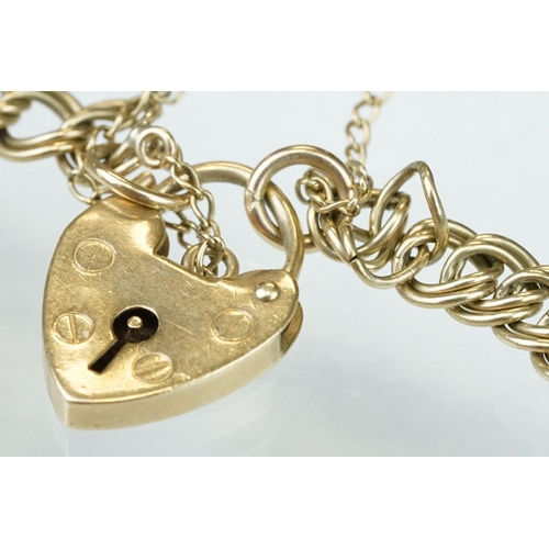 228 - 9ct yellow gold double curb link bracelet, padlock clasp,  with a 9ct gold charm