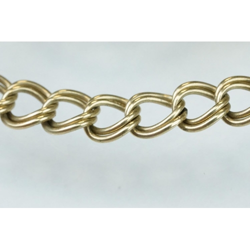 228 - 9ct yellow gold double curb link bracelet, padlock clasp,  with a 9ct gold charm