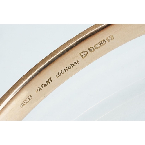 232 - 9ct rose gold hinged bangle, engraved textured design to upper half, the tongue and box clasp with s... 