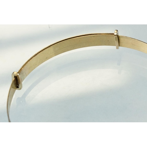 233 - 9ct yellow gold Christening bangle, engraved stylised foliate decoration, width approx 5mm