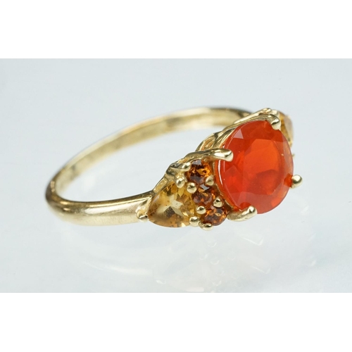 236 - Fire opal, orange garnet and citrine 14ct yellow gold ring, the round mixed cut fire opal diameter a... 