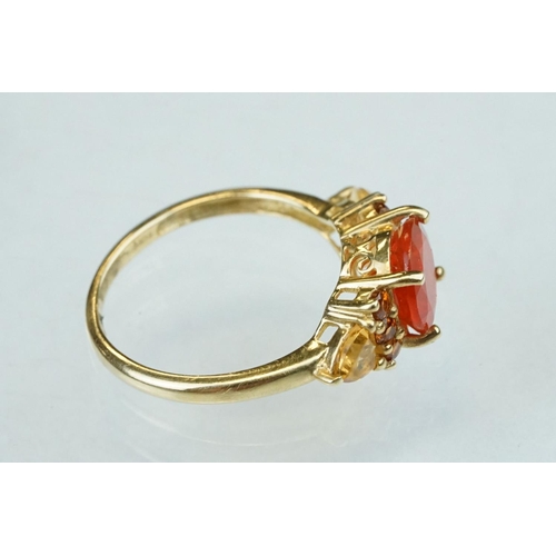 236 - Fire opal, orange garnet and citrine 14ct yellow gold ring, the round mixed cut fire opal diameter a... 