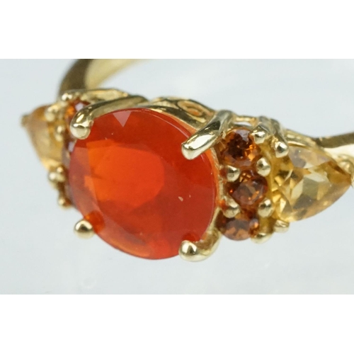 236 - Fire opal, orange garnet and citrine 14ct yellow gold ring, the round mixed cut fire opal diameter a... 