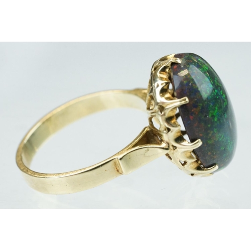 247 - Black sugar opal, yellow metal, stamped 14, ring size M½; a citrine 9ct yellow gold dress ring, size... 