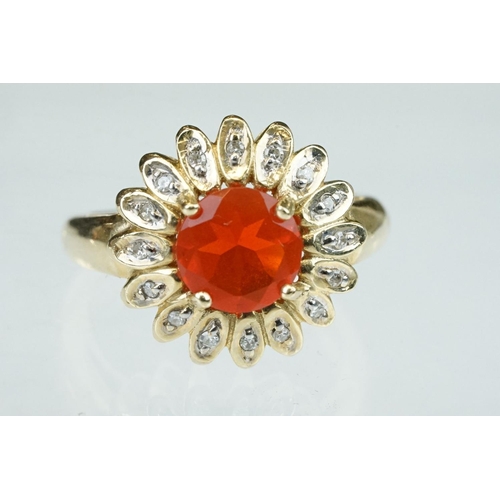 248 - Fire opal and diamond 14ct yellow gold flower head ring, the round mixed cut orange fire opal diamet... 