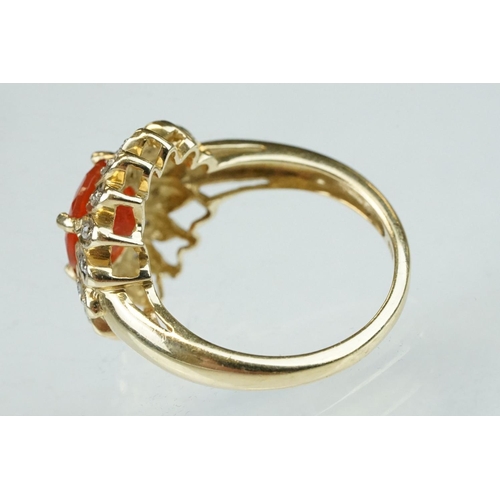 248 - Fire opal and diamond 14ct yellow gold flower head ring, the round mixed cut orange fire opal diamet... 