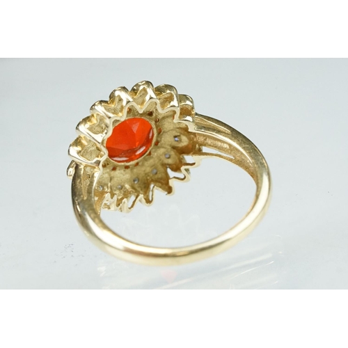 248 - Fire opal and diamond 14ct yellow gold flower head ring, the round mixed cut orange fire opal diamet... 