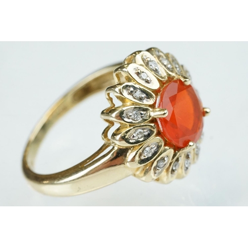 248 - Fire opal and diamond 14ct yellow gold flower head ring, the round mixed cut orange fire opal diamet... 