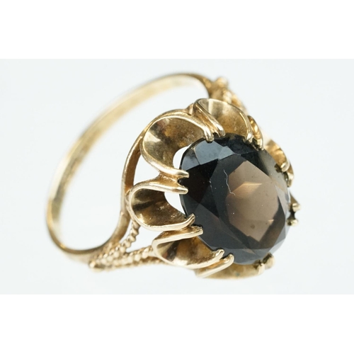 257 - Smoky quartz 9ct yellow gold ring, size Q; rose metal ring of clasped hands, ring size K; and a blue... 