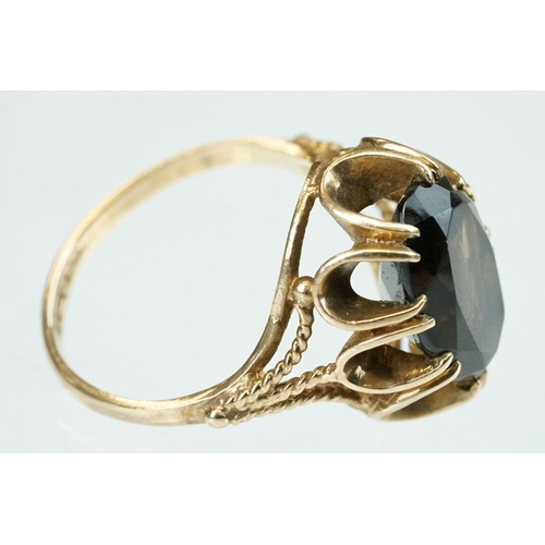 257 - Smoky quartz 9ct yellow gold ring, size Q; rose metal ring of clasped hands, ring size K; and a blue... 