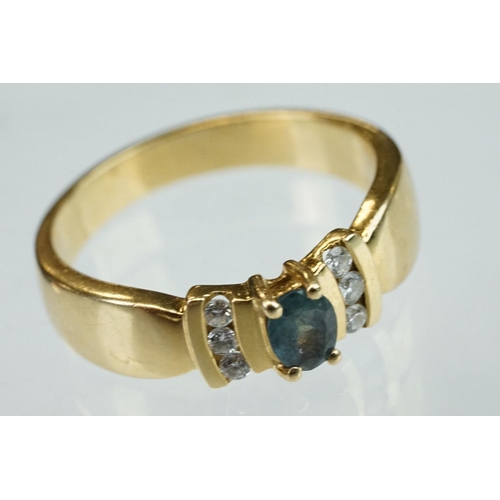 259 - Green stone and diamond 18ct yellow gold ring, the oval mixed cut green stone possibly a green sapph... 