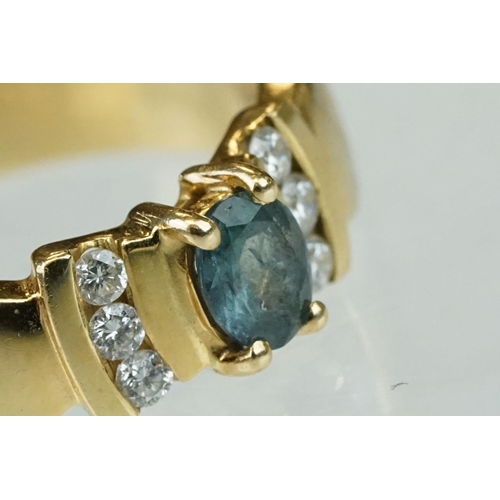 259 - Green stone and diamond 18ct yellow gold ring, the oval mixed cut green stone possibly a green sapph... 