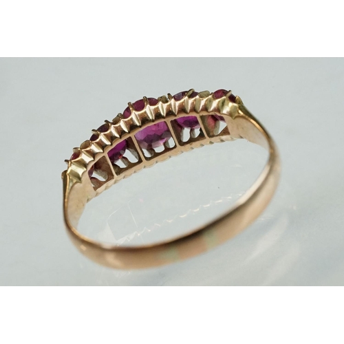 260 - Ruby rose metal ring, five graduated mixed cut rubies, the central ruby measuring approx 5mm x 4mm, ... 