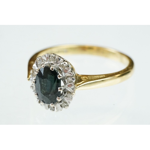 166 - Sapphire and diamond 18ct yellow and white gold set cluster ring, oval mixed cut blue-black sapphire... 