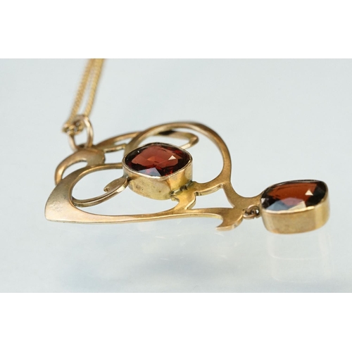 175 - Art Nouveau garnet 9ct gold pendant, two oval cushion cut garnets, rubover set, measuring approx 8mm... 