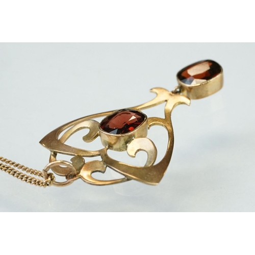 175 - Art Nouveau garnet 9ct gold pendant, two oval cushion cut garnets, rubover set, measuring approx 8mm... 