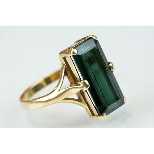 264 - Green tourmaline unmarked gold ring (hallmarks rubbed), the rectangular mixed cut tourmaline measuri... 