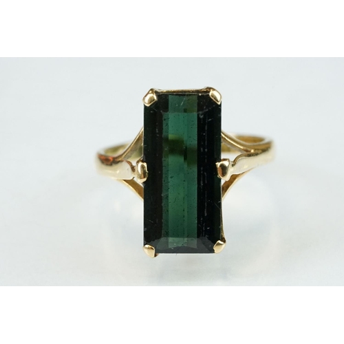 264 - Green tourmaline unmarked gold ring (hallmarks rubbed), the rectangular mixed cut tourmaline measuri... 