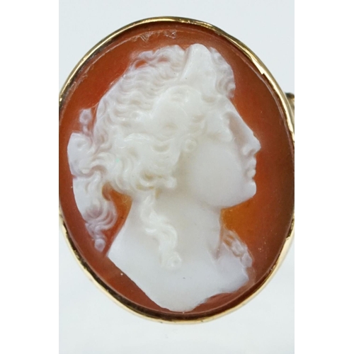 265 - Cameo 18ct yellow gold ring, the oval cameo depicting female profile, rubover set, v shaped shoulder... 