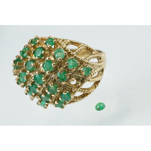 273 - Emerald 9ct yellow gold ring, twenty-two small round mixed cut emeralds, claw set (one deficient but... 