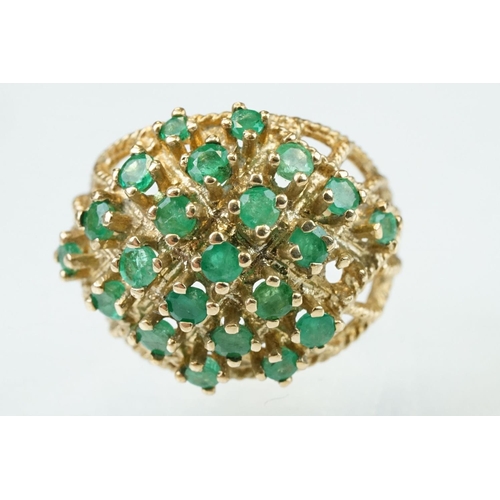 273 - Emerald 9ct yellow gold ring, twenty-two small round mixed cut emeralds, claw set (one deficient but... 