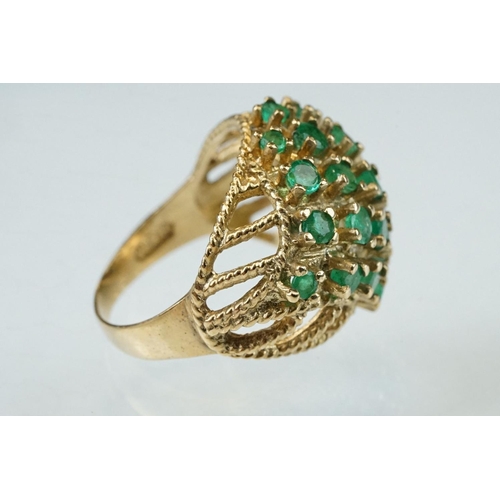 273 - Emerald 9ct yellow gold ring, twenty-two small round mixed cut emeralds, claw set (one deficient but... 