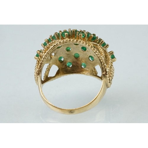 273 - Emerald 9ct yellow gold ring, twenty-two small round mixed cut emeralds, claw set (one deficient but... 