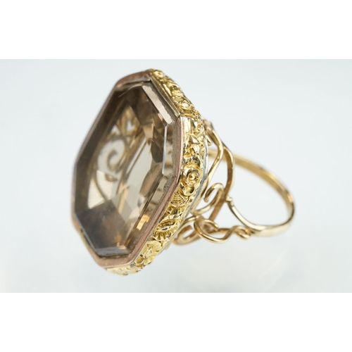 275 - Smoky quartz gold plated and yellow metal ring, the large octagonal mixed cut smoky quartz measuring... 