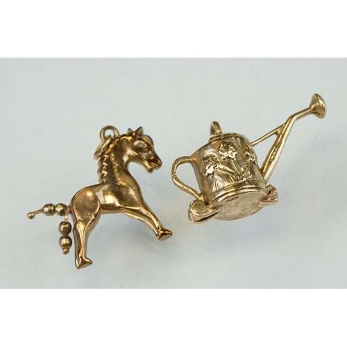 279 - Eight 9ct yellow gold charms together with two yellow metal charms (10)