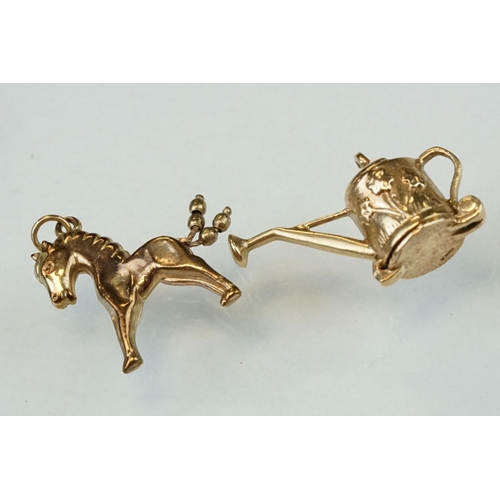 279 - Eight 9ct yellow gold charms together with two yellow metal charms (10)