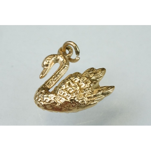 279 - Eight 9ct yellow gold charms together with two yellow metal charms (10)