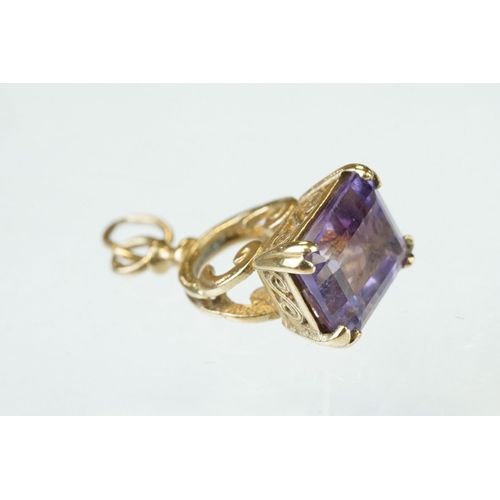 281 - Amethyst 9ct yellow gold fob, four yellow metal and gold plated charms, and a 9ct yellow item