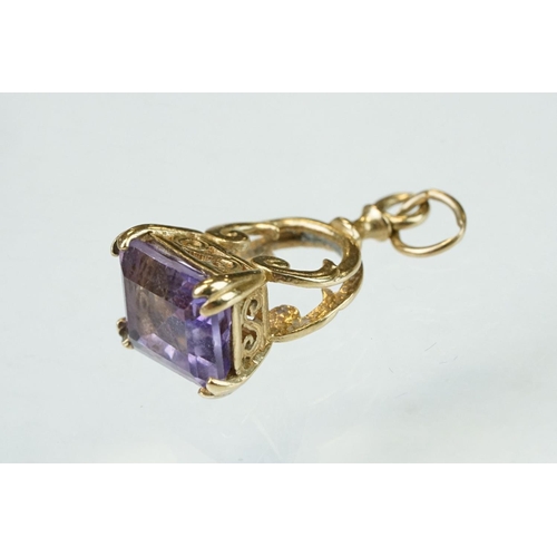 281 - Amethyst 9ct yellow gold fob, four yellow metal and gold plated charms, and a 9ct yellow item