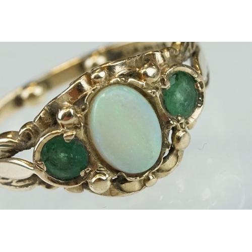 293 - Opal and emerald 9ct yellow gold ring, the oval cabochon cut precious white opal displaying green an... 