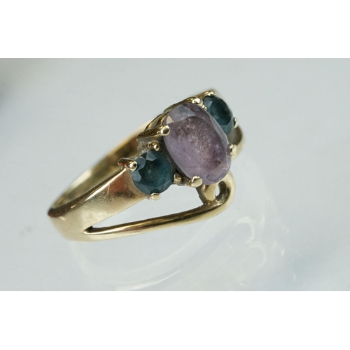 294 - Amethyst and blue stone 9ct yellow gold ring, the central oval mixed cut amethyst measuring approx 8... 