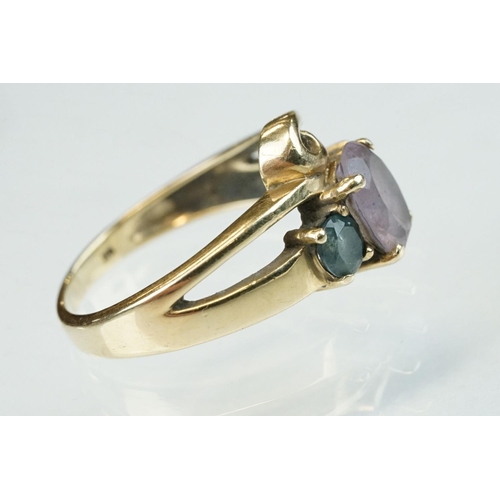 294 - Amethyst and blue stone 9ct yellow gold ring, the central oval mixed cut amethyst measuring approx 8... 