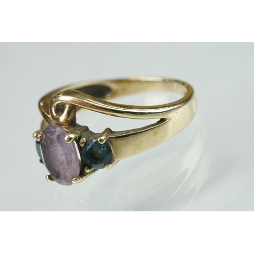 294 - Amethyst and blue stone 9ct yellow gold ring, the central oval mixed cut amethyst measuring approx 8... 