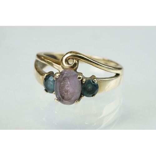 294 - Amethyst and blue stone 9ct yellow gold ring, the central oval mixed cut amethyst measuring approx 8... 