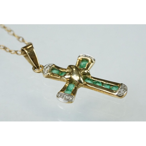 295 - Emerald and diamond 9ct yellow and white gold cross pendant and chain, ten small round mixed cut eme... 