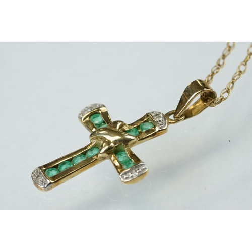 295 - Emerald and diamond 9ct yellow and white gold cross pendant and chain, ten small round mixed cut eme... 