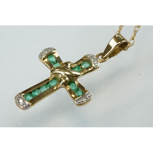 295 - Emerald and diamond 9ct yellow and white gold cross pendant and chain, ten small round mixed cut eme... 