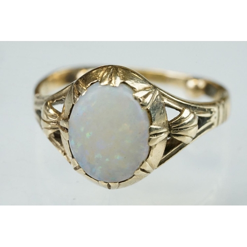 296 - Opal 9ct yellow gold ring, the oval cabochon cut opal displaying violet, indigo, green, orange and r... 