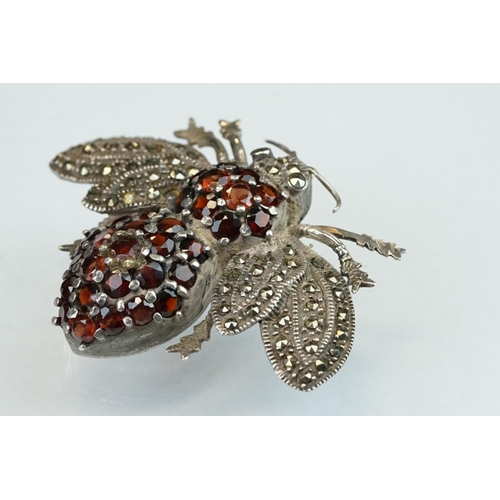 297 - Garnet and marcasite silver insect brooch, the body full set with round mixed cut garnets, the wings... 