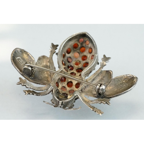 297 - Garnet and marcasite silver insect brooch, the body full set with round mixed cut garnets, the wings... 