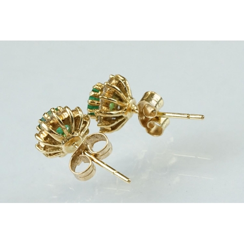 35 - Emerald and diamond 18ct yellow gold cluster earrings, the round mixed cut emerald measuring approx ... 