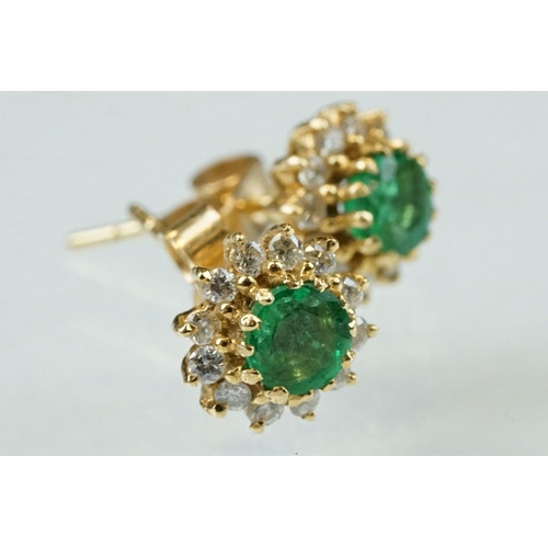 35 - Emerald and diamond 18ct yellow gold cluster earrings, the round mixed cut emerald measuring approx ... 