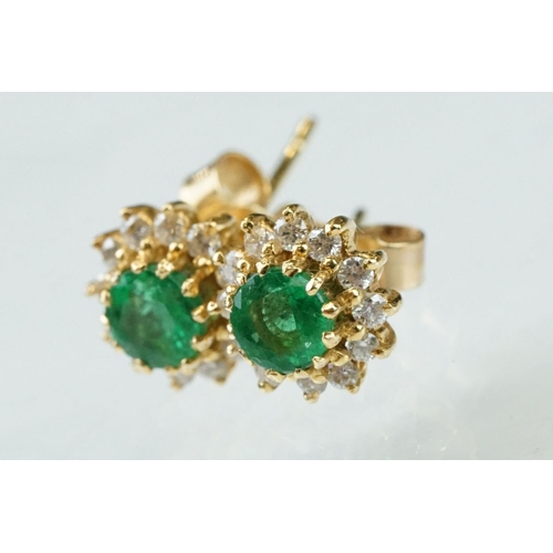 35 - Emerald and diamond 18ct yellow gold cluster earrings, the round mixed cut emerald measuring approx ... 