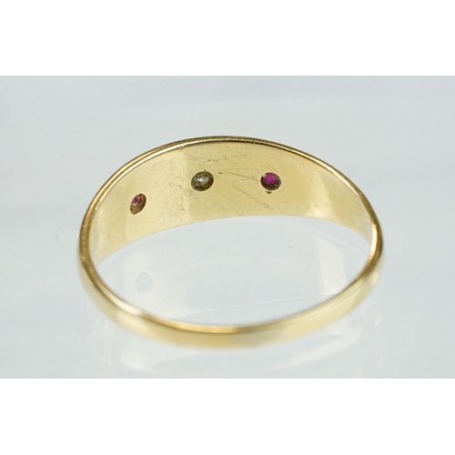 364 - Diamond and ruby 18ct yellow gold three stone ring, the central round old cut diamond weighing appro... 