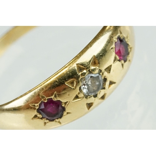 364 - Diamond and ruby 18ct yellow gold three stone ring, the central round old cut diamond weighing appro... 