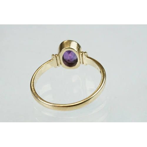 52 - Amethyst 9ct yellow gold ring, the oval mixed cut amethyst measuring approx 6.5mmx 4.5mm, rubover se... 